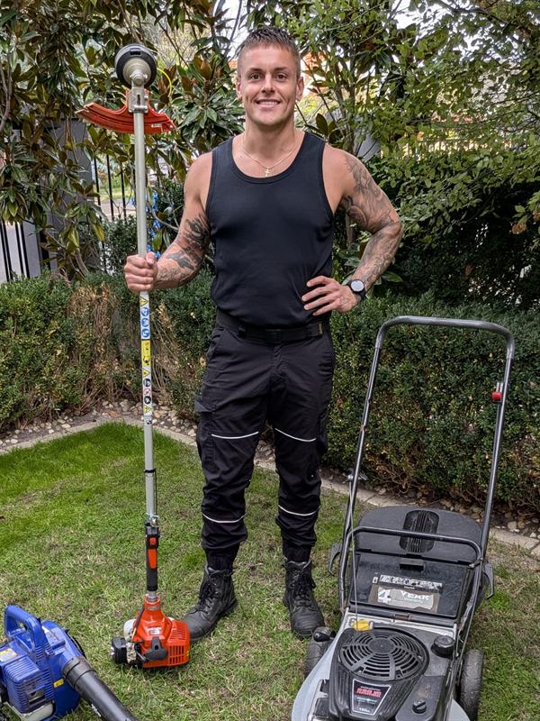 Stephen Wilson of Wilson's Mowing on a freshly mown Bayside lawn with his mower, line trimmer and blower